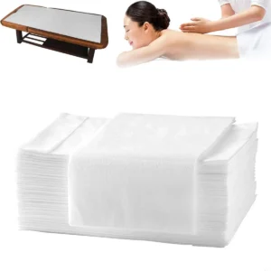 A pack of 100 white 32x71 inch disposable bed sheets, waterproof and ideal for spas, massage tables, tattoo parlors, hotels, and beauty salons.