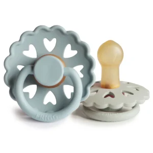 This 2-pack of FRIGG Fairytale pacifiers in stone blue and willow grey features a round, cherry-shaped natural rubber nipple, heart-shaped ventilation holes, and a curved polypropylene shield for newborns 0-6 months.