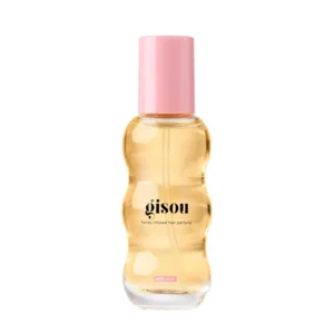 A small bottle of Gisou Honey Infused Hair Perfume in Wild Rose scent, designed to refresh and delicately scent hair with argan oil.