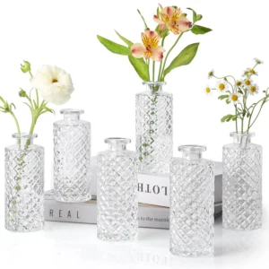 Set of six small, clear glass bud vases with a diamond pattern, perfect for displaying single flowers or creating elegant centerpieces.