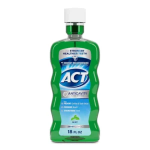 A bottle of ACT Anticavity Fluoride Rinse that kills bad breath, strengthens enamel, and restores minerals.