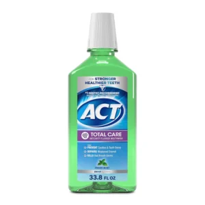 A bottle of ACT Total Care Zero Alcohol Anticavity Fluoride Mouthwash in Fresh Mint flavor helps prevent cavities and freshen breath.