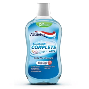 Bottle of Aquafresh Complete Care fresh mint mouthwash offering triple protection against bad breath, cavities, and plaque, with fluoride for 24-hour defense against sugar acid.