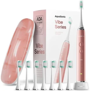 Satin rose gold Aquasonic Vibe Series electric toothbrush with wireless charging, travel case and DuPont brush heads for whitening and complete oral care.