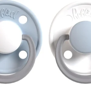 Two Rebael natural rubber round pacifiers in arctic and snow colors, designed for babies 6-18 months, offering safe and comforting soothing.