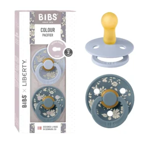 Bibs x Liberty 2-pack of size 2 latex pacifiers in a dusty blue Capel print, designed with a round nipple to mimic breastfeeding.