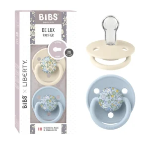 Two-pack of BIBS x Liberty De Lux pacifiers in Eloise Baby Blue Mix, featuring a round cherry-shaped silicone nipple designed to support the correct sucking technique for breastfeeding babies aged 0-36 months.