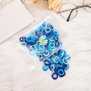 This image shows a vibrant blue collection of one hundred hair ties and small rubber bands, perfect hair accessories for women's daily use and styling needs.
