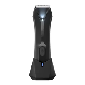 Waterproof body hair trimmer for men with LED light, designed for pubic and groin grooming with replaceable guard combs and a charging dock.