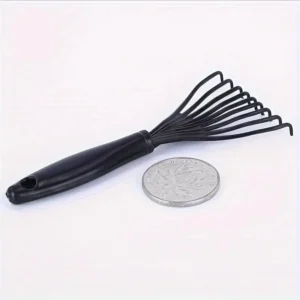 This is a mini black comb cleaner designed to efficiently remove hair from hairbrushes and claw detanglers.