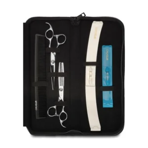 The CreaClip set with hair scissors, thinning scissors, and a comb are displayed in a storage case, ideal for DIY haircuts and bang trims at home, saving time and money.