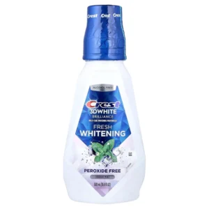 Bottle of Crest 3D White Brilliance Clean Mint mouthwash that safely whitens teeth in 7 days without peroxide or alcohol, removing surface stains with brushing.