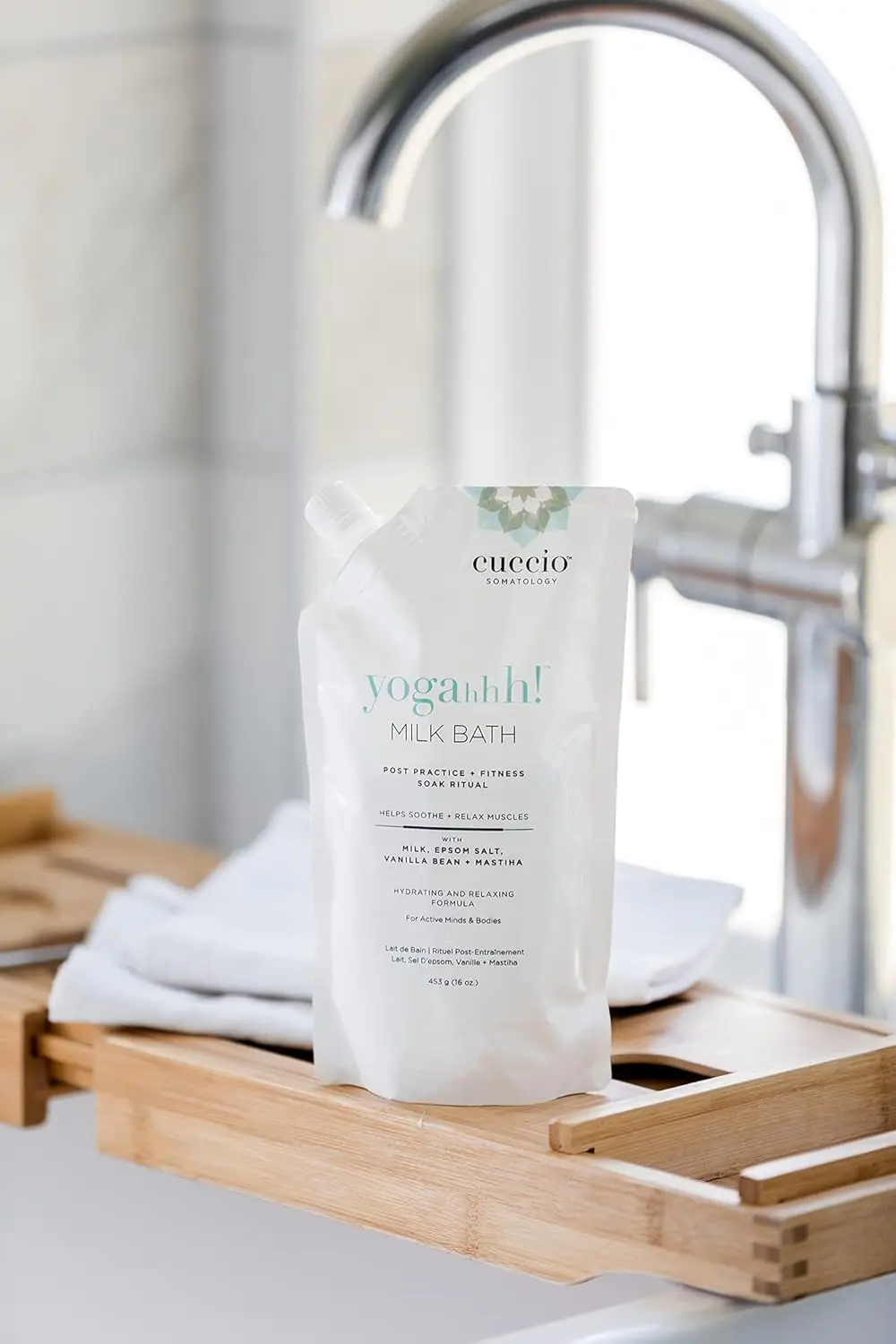 Cuccio Somatology milk bath soaking in water helps relieve sore muscles and hydrate dry skin for full body wellness and relaxation.