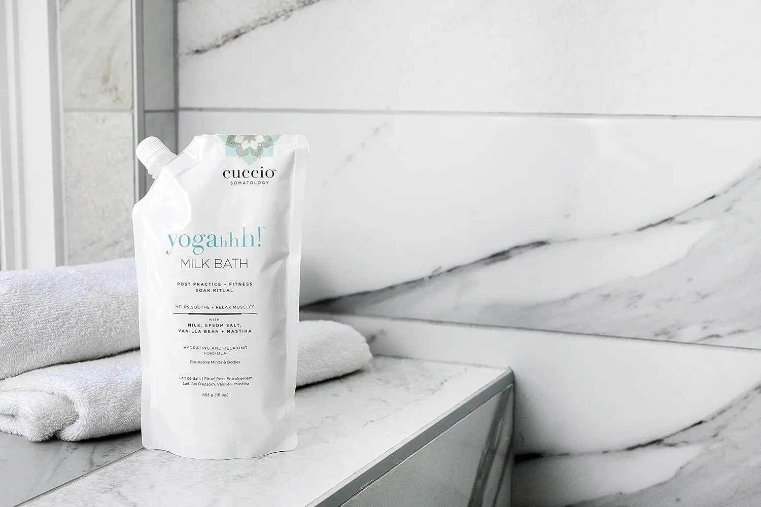 Cuccio Somatology milk bath soaking in water helps relieve sore muscles and hydrate dry skin for full body wellness and relaxation.