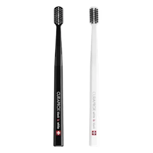 This pack contains two black and white Curaprox ultra-soft toothbrushes with 8,760 CUREN filaments for gentle yet effective plaque removal, ideal for sensitive teeth and gums.