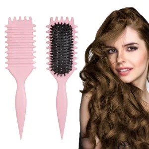 This pink curl defining brush is designed with an ergonomic handle and open vent for effortless styling, detangling, and shaping of all curl types.