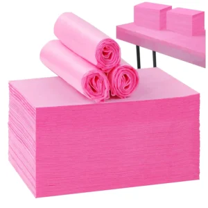 This image shows a pack of 100 pink disposable massage table sheets made of non-woven fabric, measuring 31 x 71 inches, ideal for spas, beauty salons, and tattoo parlors.
