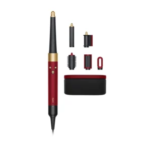 The Dyson Airwrap I.D. multi-styler in red velvet and gold, with its various attachments, automatically creates perfect, consistent curls without heat damage.