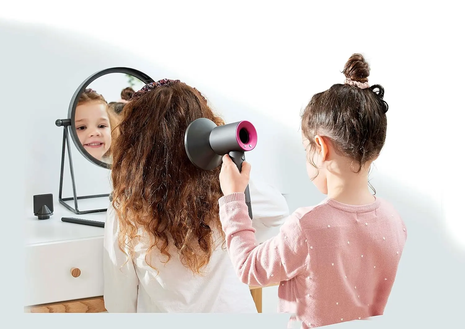 This Dyson Supersonic hair dryer styling set includes a concentrator, diffuser, brush, and detangling comb for creating a variety of hairstyles.