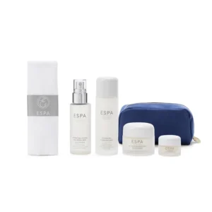 This ESPA winter hydration set includes four skincare products to combat dryness, including cleansing milk, floral mist, moisturizer, and overnight mask, presented in a reusable cosmetic bag with a dual action cotton cleansing cloth, perfect for gifting.