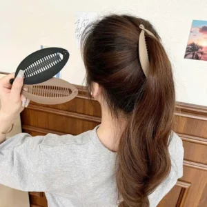 Three elegant fish-shaped banana hair claw clips provide a minimalist and fashionable way to style women's hair.