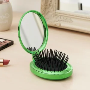 This is a compact, green folding hair brush with a built-in mirror, perfect for on-the-go styling.