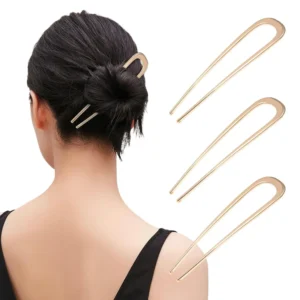 Three metal french hair pins in gold, silver, and black, ideal for creating elegant buns, twists, and chignon hairstyles for women.
