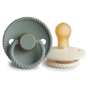 A 2-pack of FRIGG Rope latex pacifiers in cream and sage colors, made with natural rubber and designed with a symmetrical cherry-shaped nipple for babies 0-6 months.