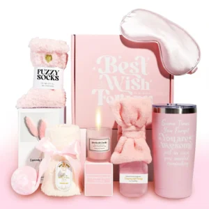 This pink gift basket includes a tumbler, candle, soap, bath bomb, towel, eye mask, headband, socks, and a greeting card, making it a perfect relaxation gift for women.