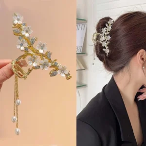 A gold flower hair clip with pearl and rhinestone tassel is a chic styling accessory.