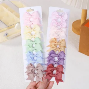 A selection of 20 colorful grosgrain ribbon hair bows attached to alligator clips, perfect hair accessories for women and teens.
