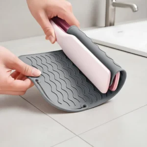 Gray heat resistant silicone mat for protecting surfaces from hot hair styling tools like flat irons and curling wands.