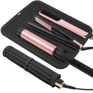 This large silicone heat mat protects surfaces from hot hair tools like curling irons and flat irons, featuring a velcro strap for easy travel and storage at home or in a salon.