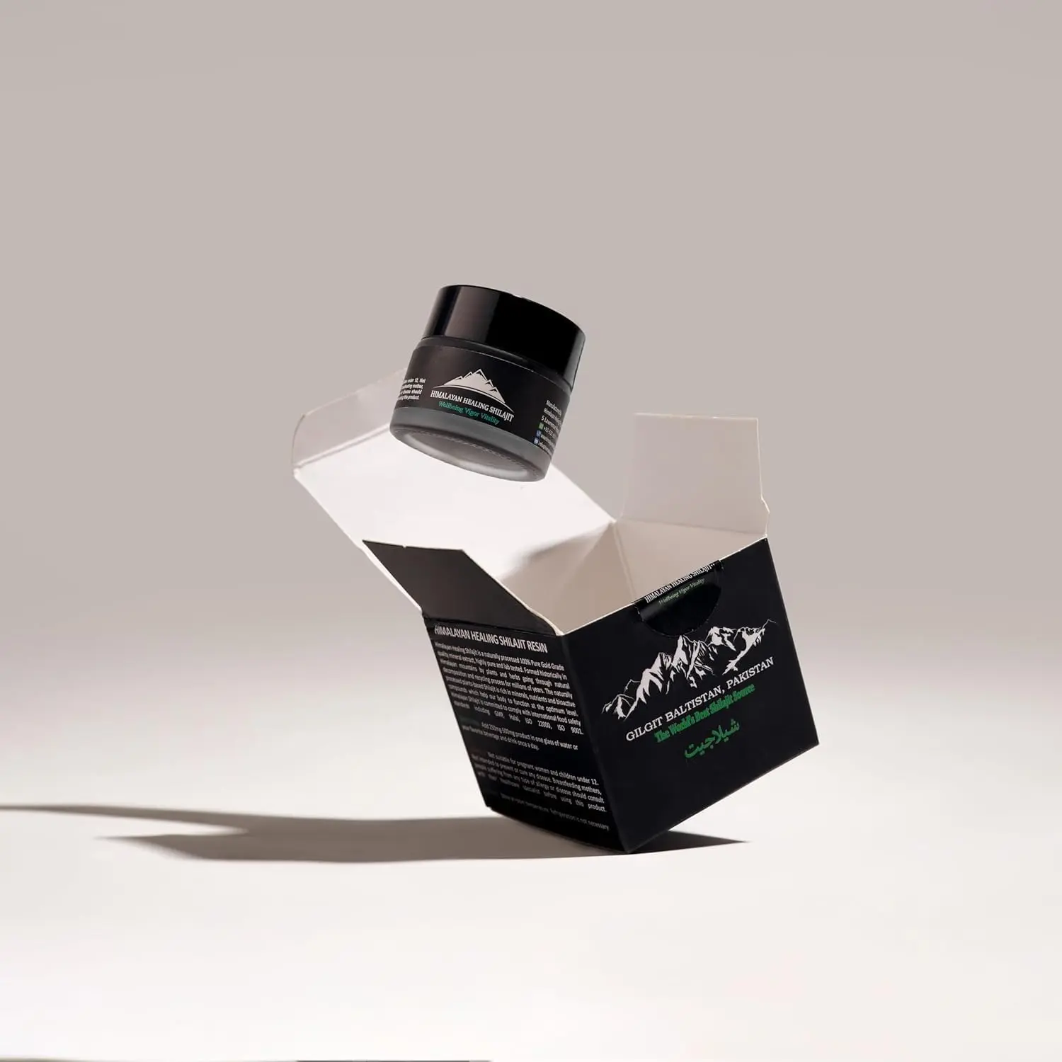 A jar of pure Himalayan Shilajit resin, a potent rejuvenator sourced from 16000 feet, known for its anti-aging properties.