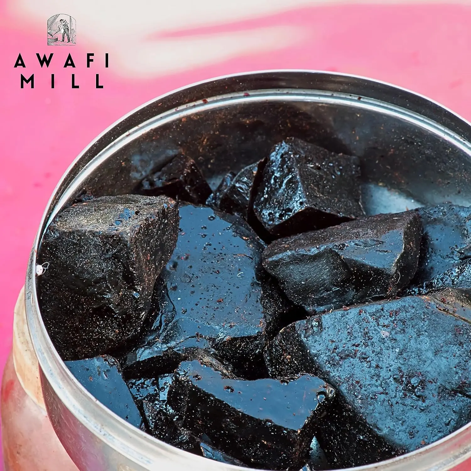 Dark brown Himalayan Shilajit resin chunks from Awafi Mill, ready to dissolve in warm water for a natural mineral supplement.