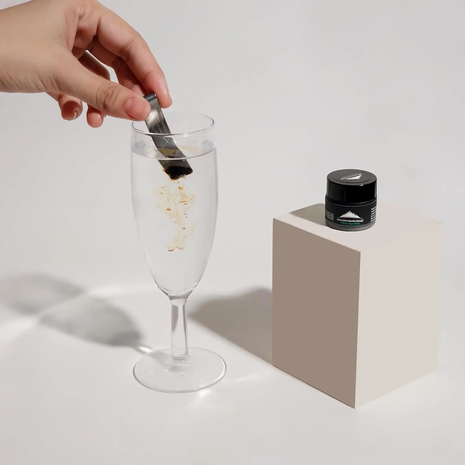 A jar of pure Himalayan Shilajit resin, a potent rejuvenator sourced from 16000 feet, known for its anti-aging properties.