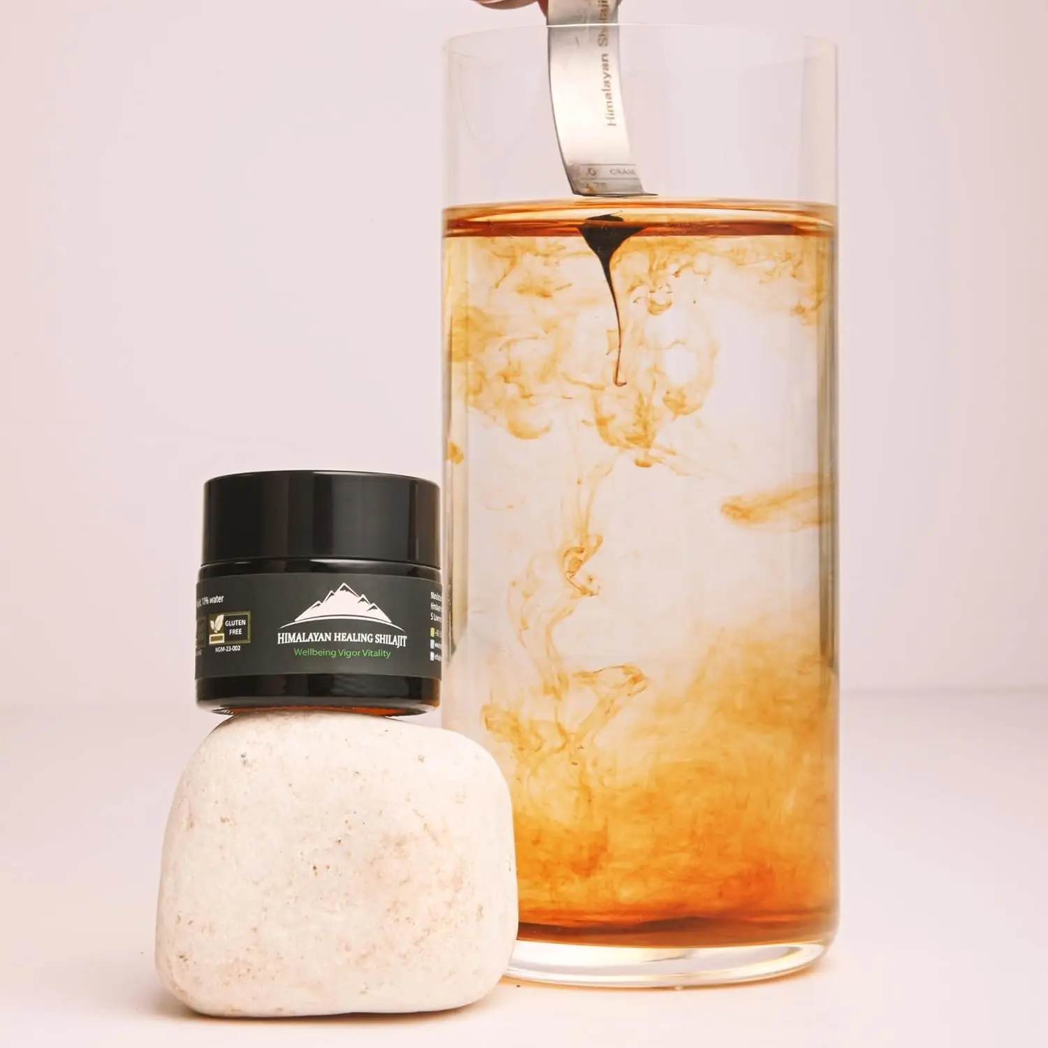 A jar of pure Himalayan Shilajit resin, a potent rejuvenator sourced from 16000 feet, known for its anti-aging properties.