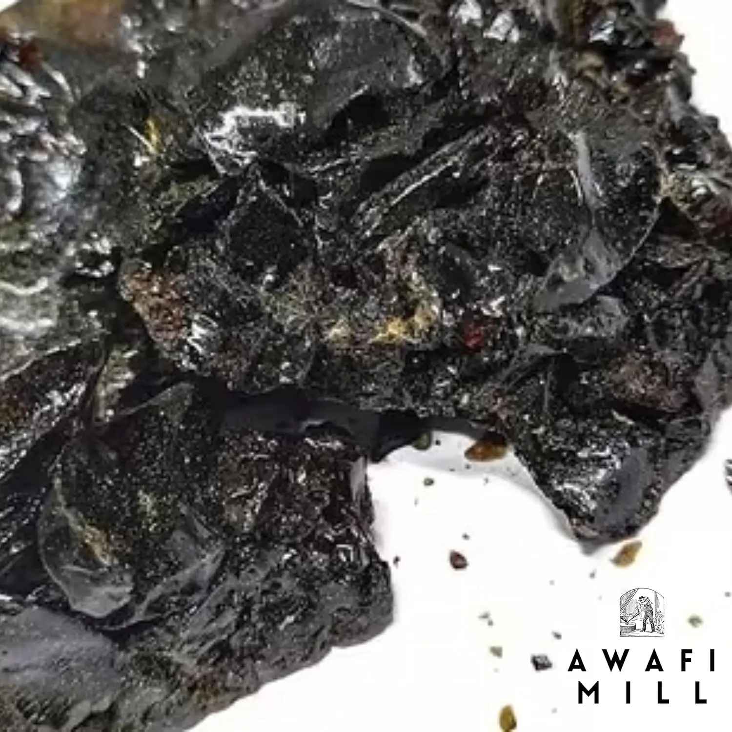 Dark brown Himalayan Shilajit resin chunks from Awafi Mill, ready to dissolve in warm water for a natural mineral supplement.