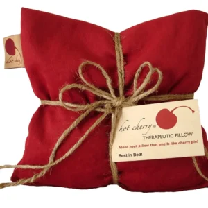 Red denim cherry pit pillow provides hot or cold therapy for muscle and joint pain relief.