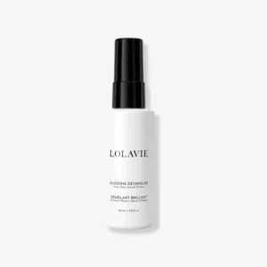 LolaVie Glossing Detangler travel size spray bottle, a 99% naturally-derived formula that detangles, enhances shine, and protects hair from heat damage up to 450°F.