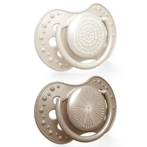 Two beige Lovi Harmony Dynamic silicone soothers for babies aged 6-18 months, designed to prevent bite reflexes and ensure easy breathing while supporting proper oral development.