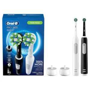 Two Oral-B Pro 1000 electric toothbrushes powered by Braun, with CrossAction brush heads and chargers, for removing plaque and improving gum health.