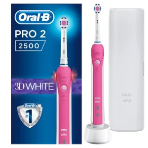 An adult using a pink Oral-B PRO 2500 automatic electric toothbrush with a plastic handle.