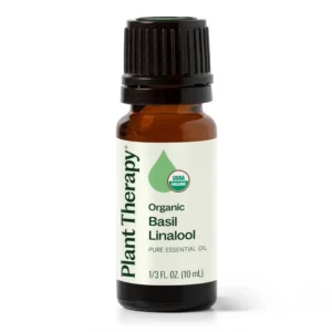 Plant Therapy organic basil linalool essential oil in a small amber bottle, steam distilled from basil leaves for a sweet, herbaceous, and uplifting aroma.