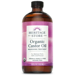 Heritage Store organic castor oil in a dark glass bottle, used for hair growth, eyebrow enhancement, and skin moisturizing, showcasing its pure and natural cold-pressed hexane-free formula.