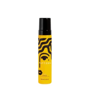 PATTERN Curl Mousse by Tracee Ellis Ross is a lightweight foam that defines and volumizes curly hair, enhancing 3B-4C patterns with softness and shine for styles like wash-and-gos and finger coils.