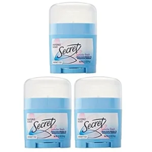 Three 0.5 oz travel-sized sticks of Secret Powder Fresh invisible solid deodorant for women, offering pH balanced odor and wetness protection.