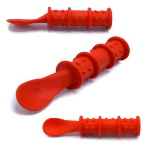 A baby uses a Therapro sensory spoon to feed themselves, promoting independent eating habits for infants as young as seven months old.