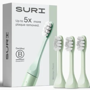 A pack of three winter fern SURI electric toothbrush replacement heads made with plant-based bristles and a built-in tongue scraper for a sustainable and complete clean.