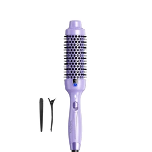 The Wavytalk thermal brush is purple and creates a voluminous blowout look in just 10 minutes, smoothing hair and reducing frizz.